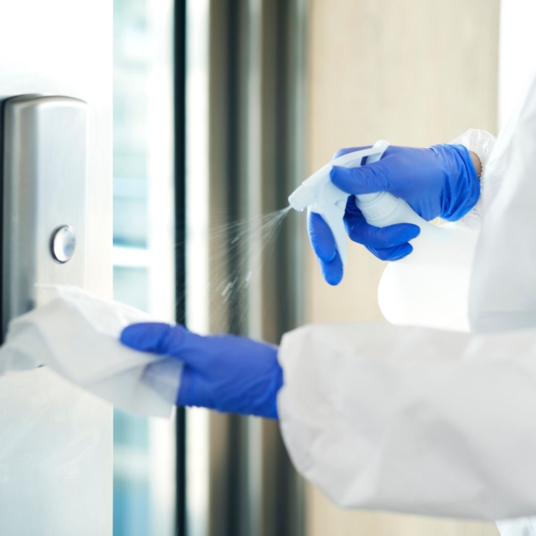 Spraying cleaner onto cloth