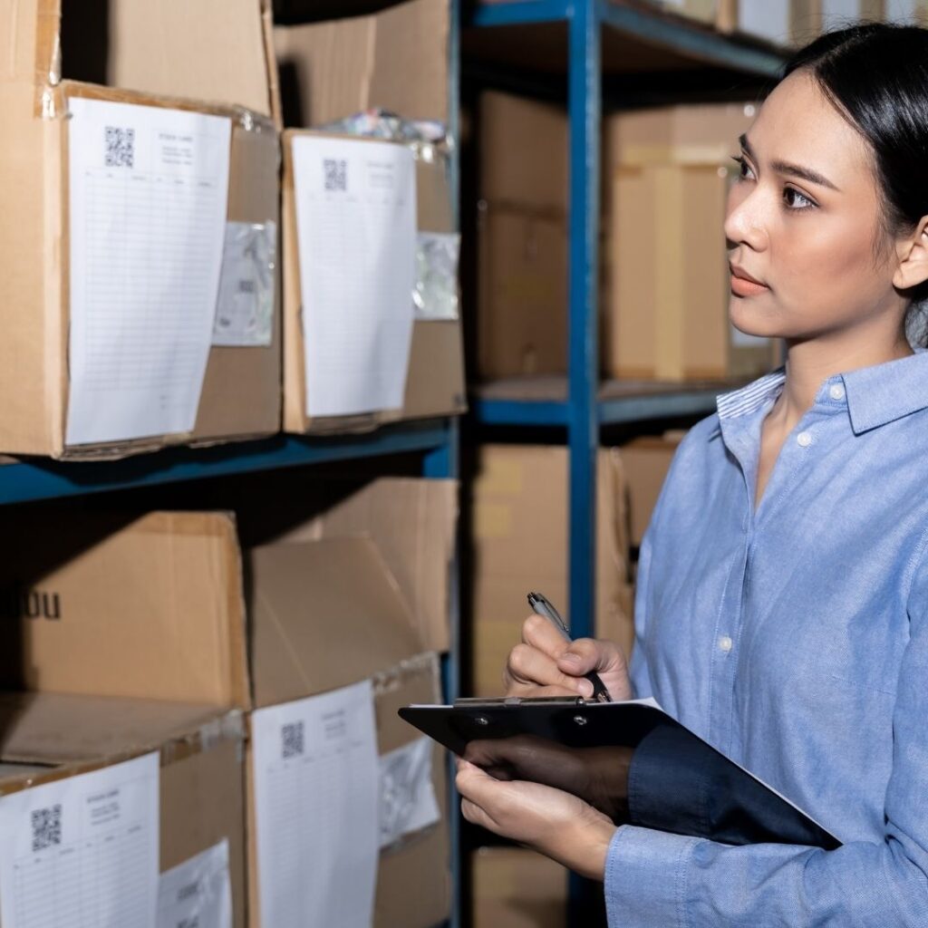woman making notes about cleaning supply inventory