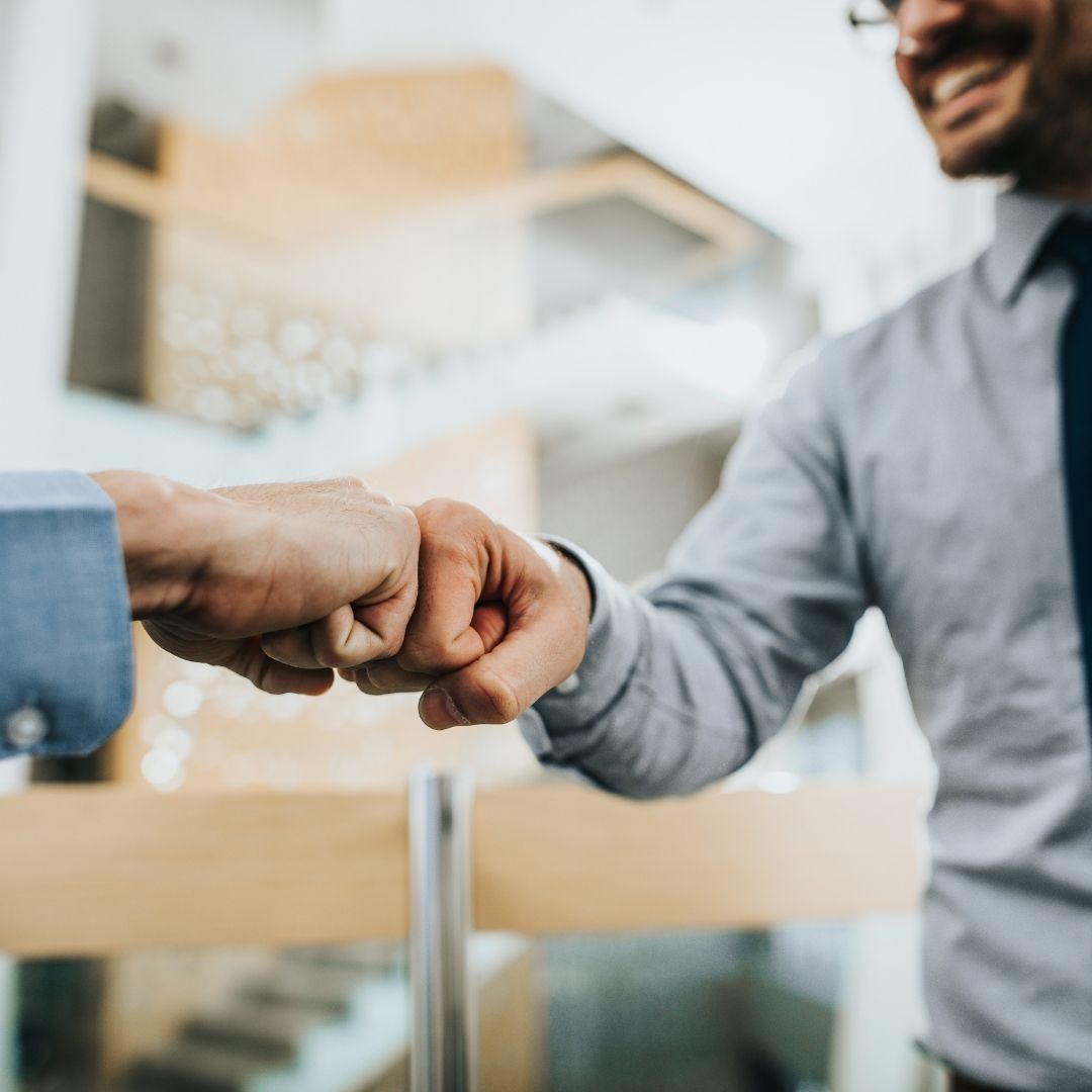 man fist bumping someone