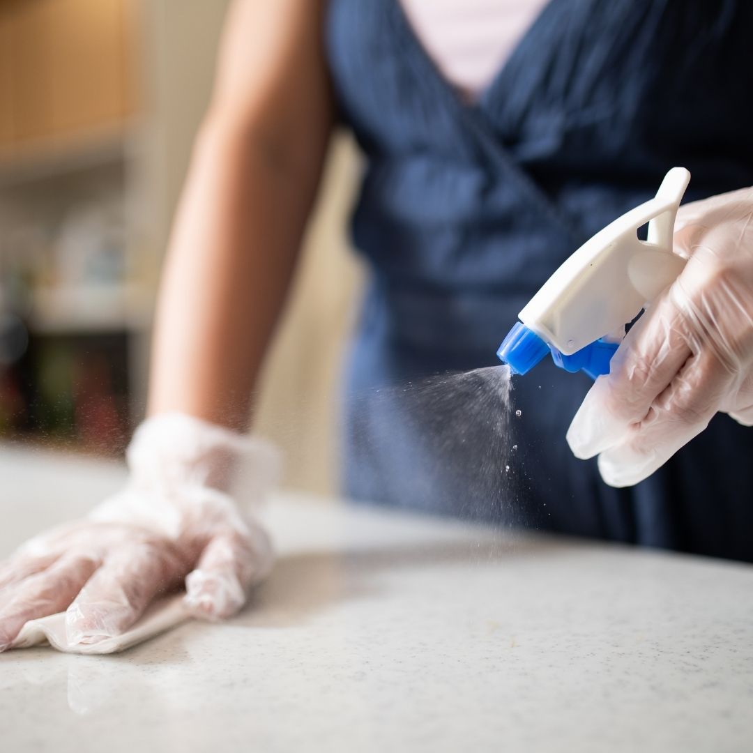woman wiping counter