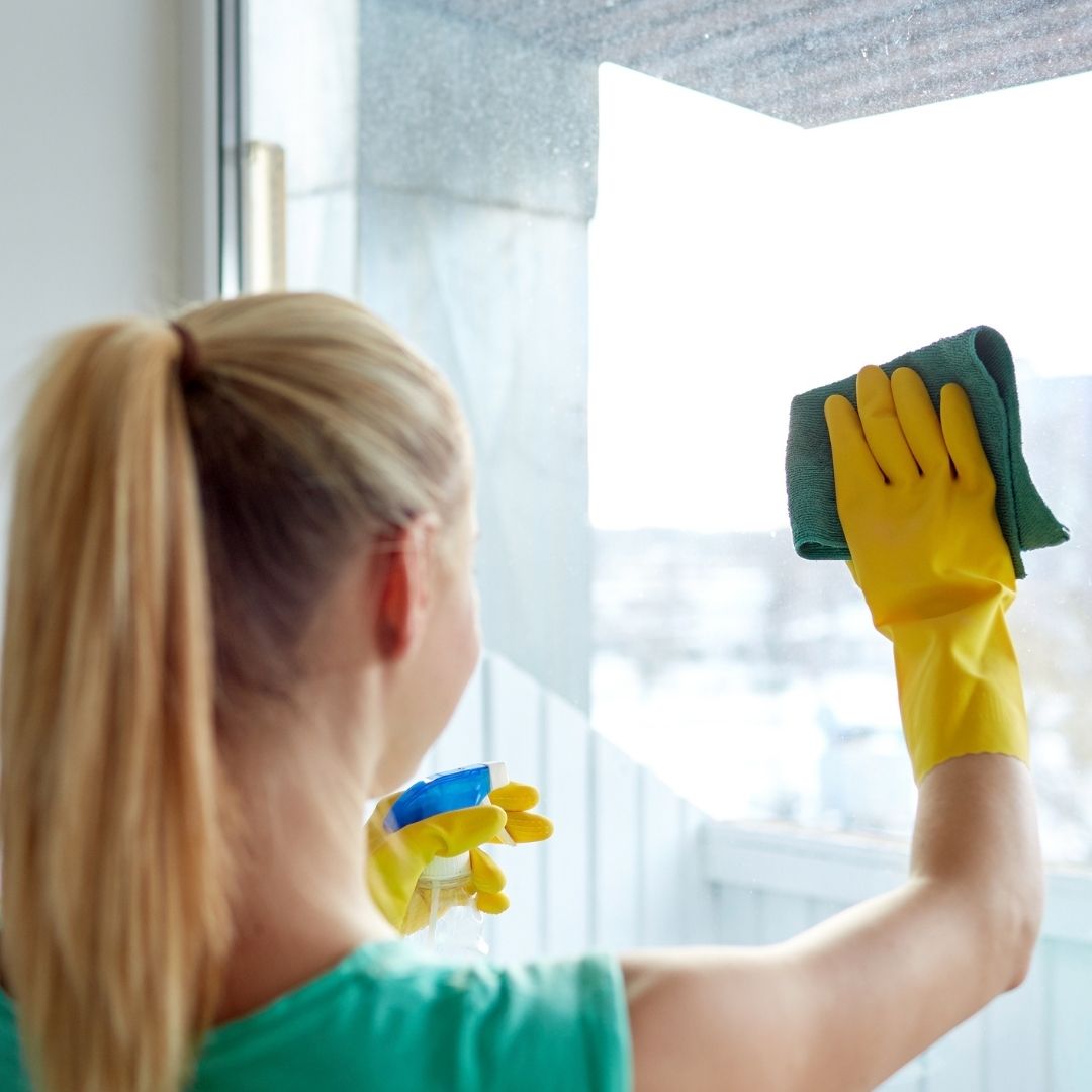woman cleaning window